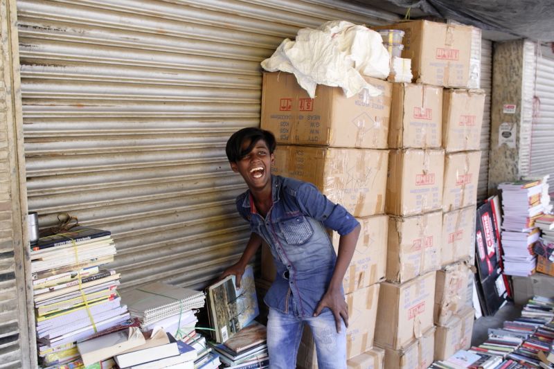 A young man selling second hand books in the weekly market